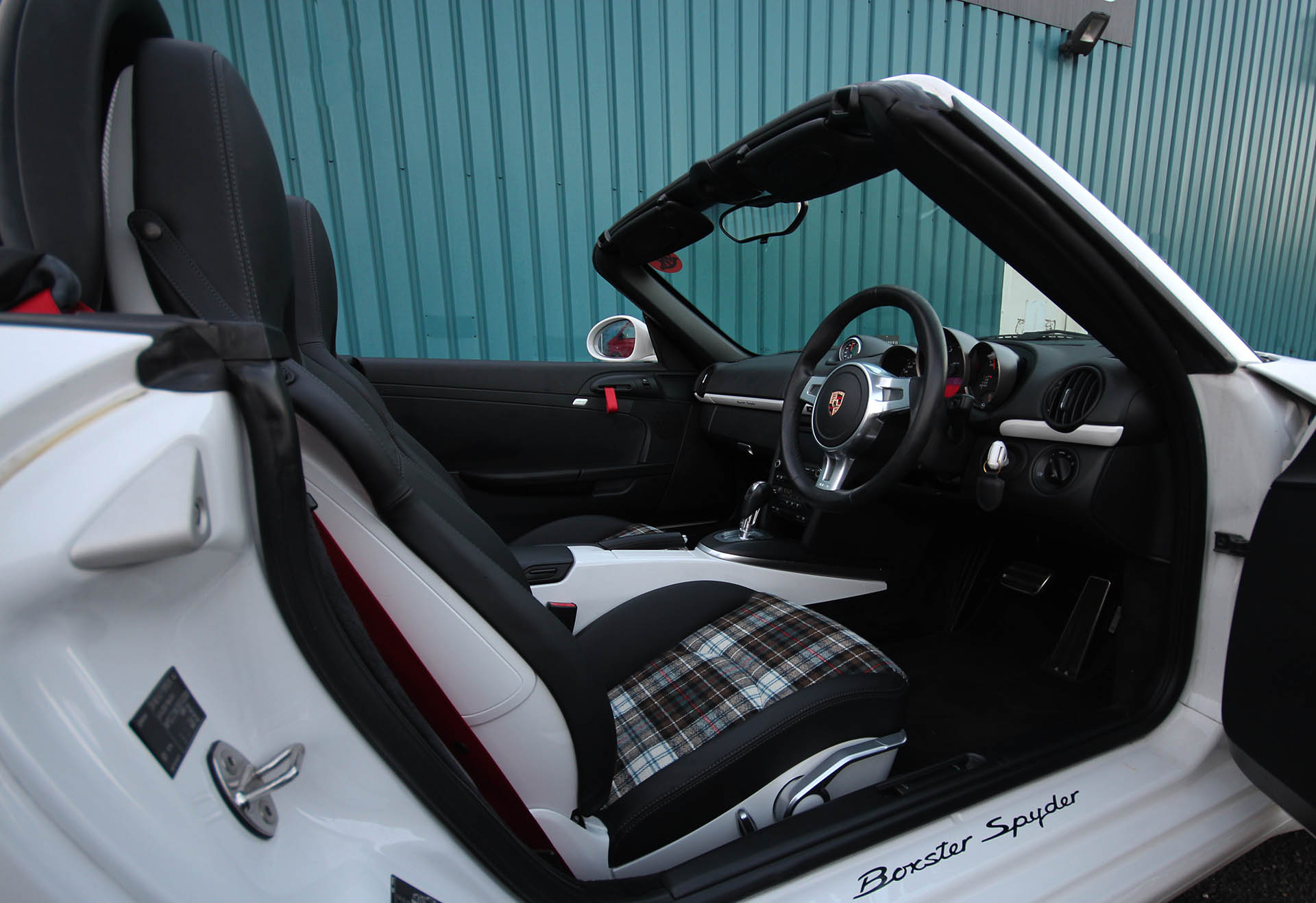 Porsche 987 Boxster Spyder custom interior by Designls ltd finished in turbo tartan seat inserts and black leather